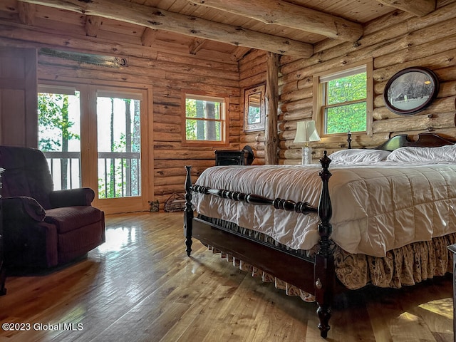 bedroom featuring log walls, wooden ceiling, wood-type flooring, and beamed ceiling