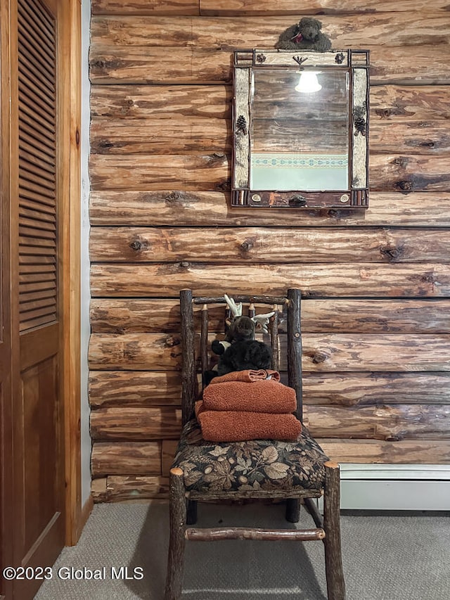 interior details with dark colored carpet and rustic walls