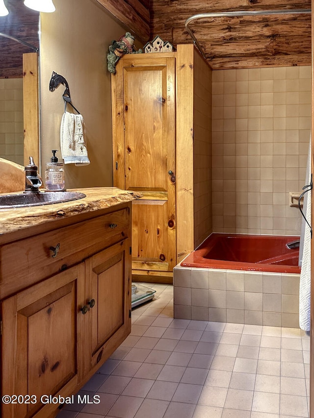 bathroom with tile floors, vanity, and tiled shower / bath