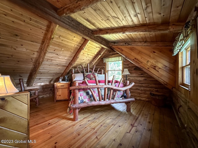 unfurnished bedroom with wooden walls, wood ceiling, lofted ceiling with beams, and light hardwood / wood-style flooring