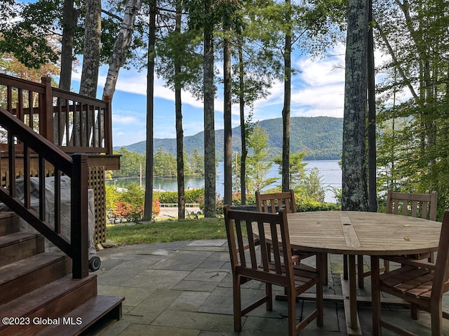 view of patio featuring a water and mountain view