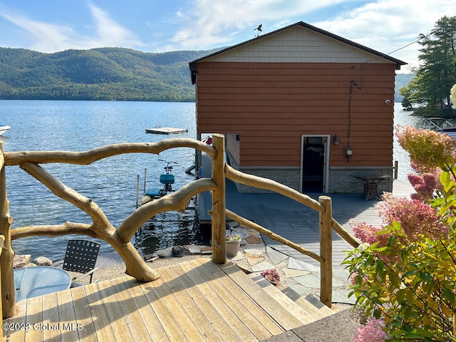 view of dock with a water and mountain view