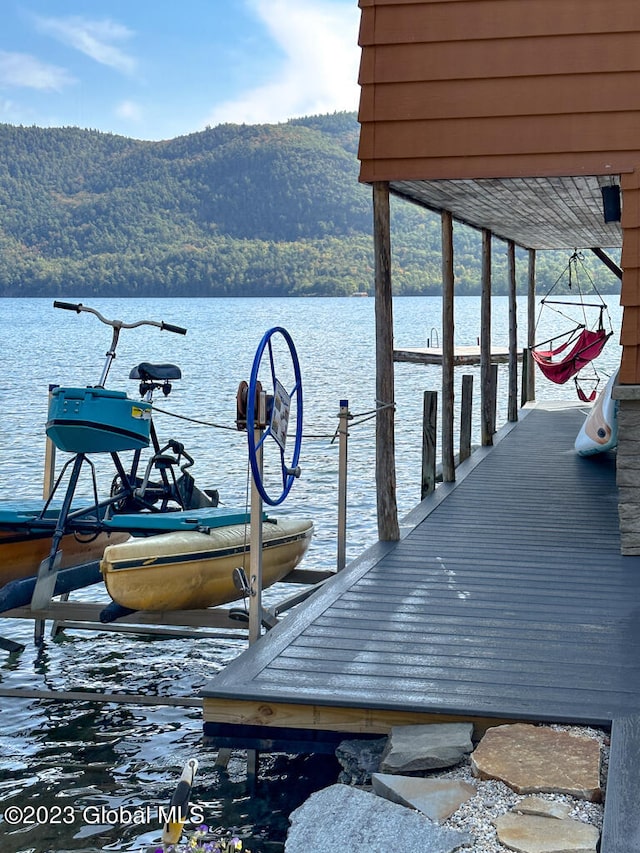 view of dock with a water and mountain view