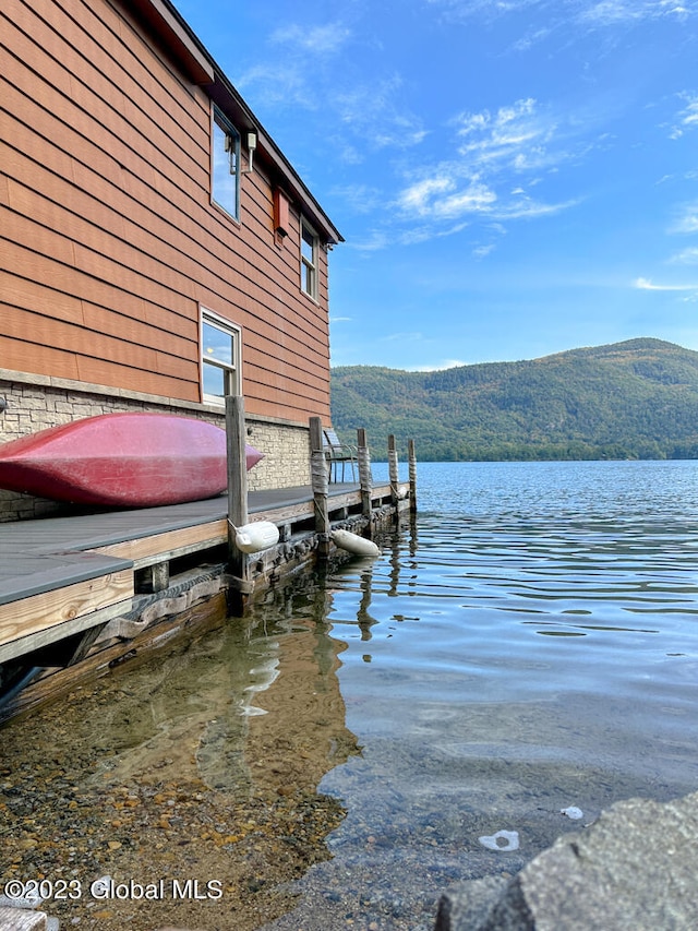 view of dock featuring a water and mountain view