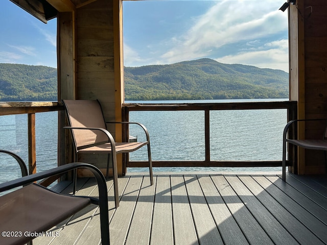 balcony featuring a water and mountain view