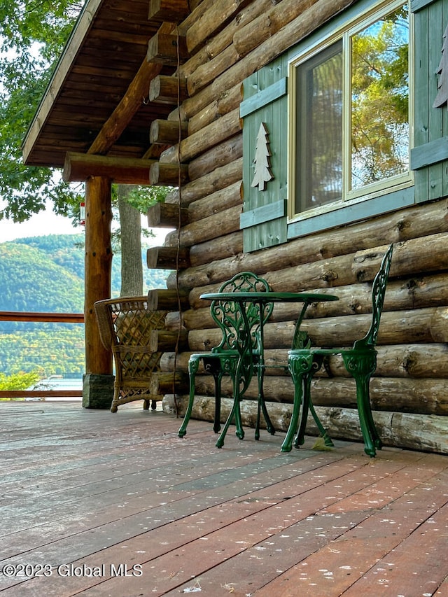 wooden deck with a mountain view