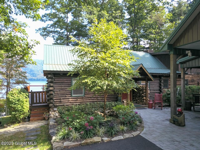 exterior space featuring a water view and a patio area