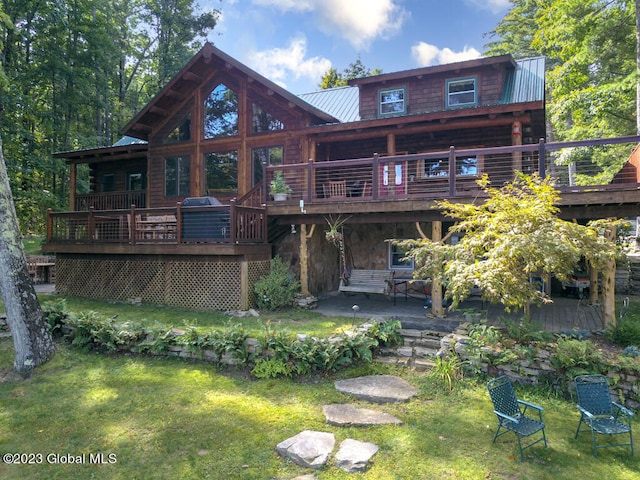 back of house with a lawn, a patio, and a deck