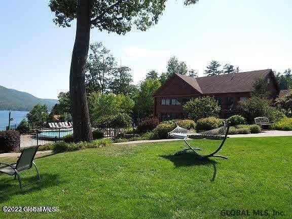 view of yard featuring a fenced in pool and a water view