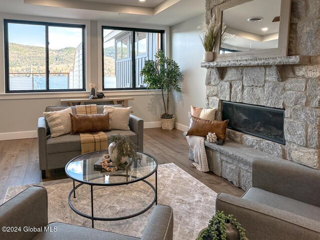 1 Kurosaka Ln Unit B, Lake George Village, NY 12845 - living room featuring a stone fireplace and hardwood / wood-style flooring