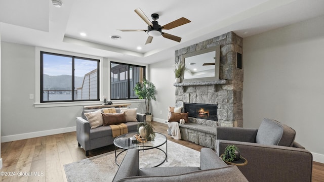 1 Kurosaka Ln Unit B, Lake George Village, NY 12845 - living room featuring ceiling fan, a raised ceiling, a fireplace, and light hardwood / wood-style flooring