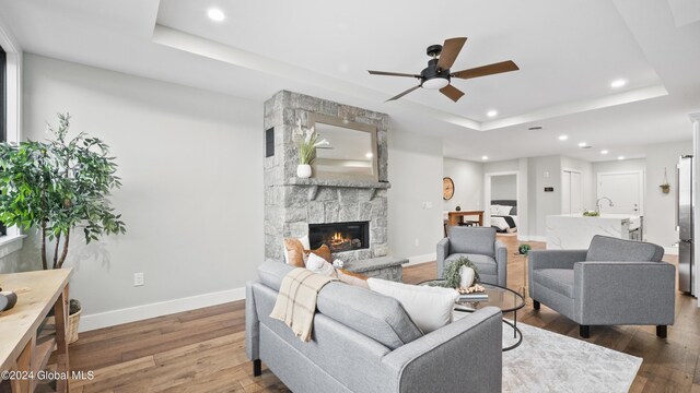 1 Kurosaka Ln Unit B, Lake George Village, NY 12845 - living room featuring a raised ceiling, a fireplace, ceiling fan, and dark hardwood / wood-style flooring