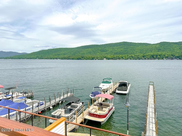 view of dock featuring a water and mountain view