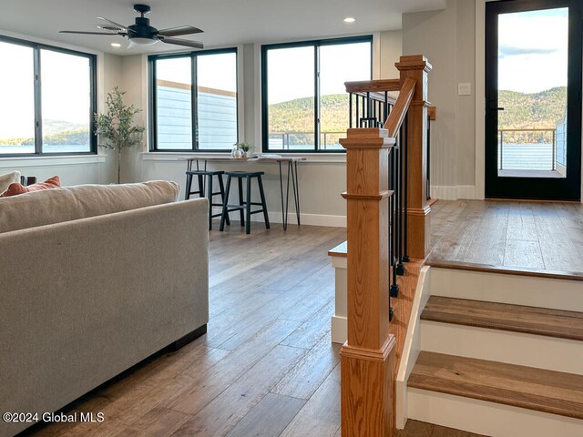 living room featuring ceiling fan and light wood-type flooring