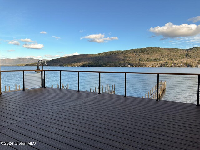 view of dock with a water and mountain view