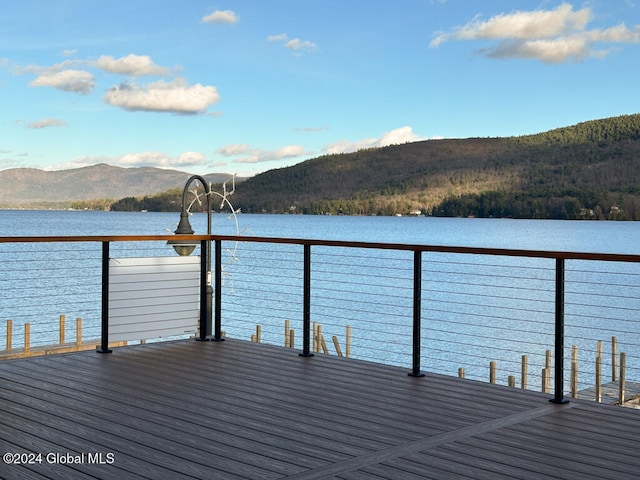 view of dock with a water and mountain view