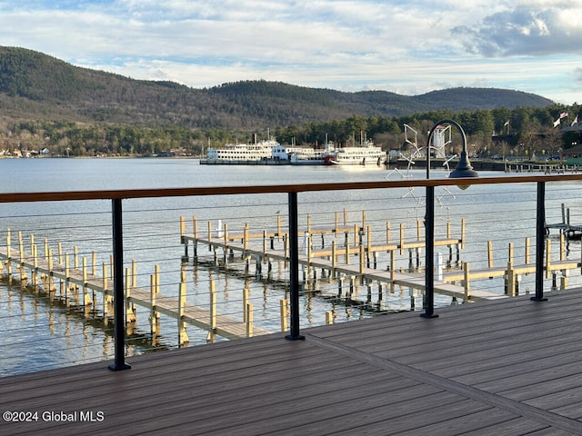 view of dock featuring a water and mountain view