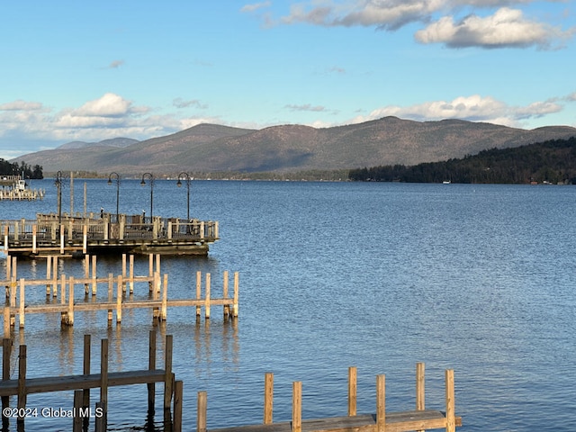 view of dock featuring a water and mountain view