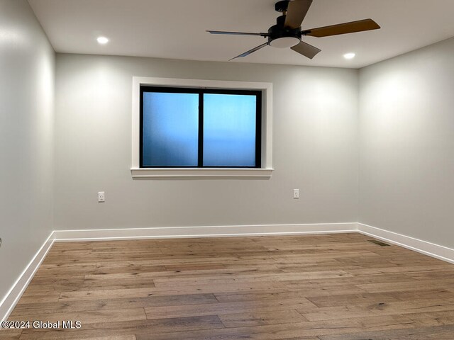 spare room with ceiling fan and light hardwood / wood-style flooring