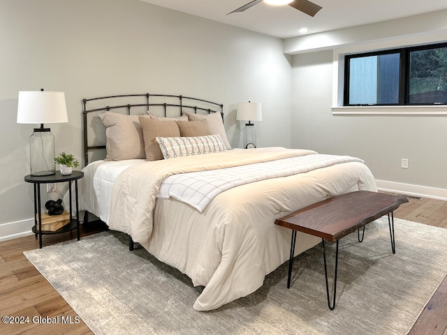 bedroom with ceiling fan and hardwood / wood-style floors