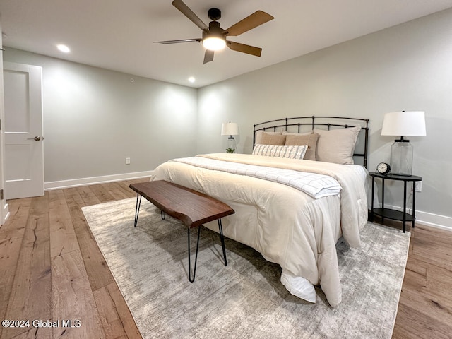 bedroom with ceiling fan and light hardwood / wood-style flooring