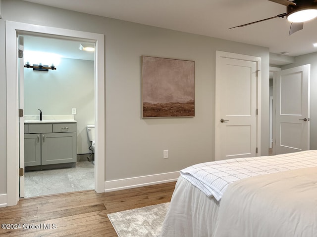 bedroom with sink, light hardwood / wood-style floors, ceiling fan, and ensuite bathroom