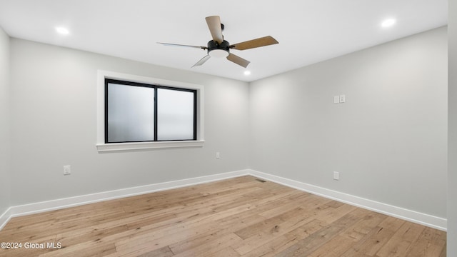 empty room with ceiling fan and light hardwood / wood-style floors