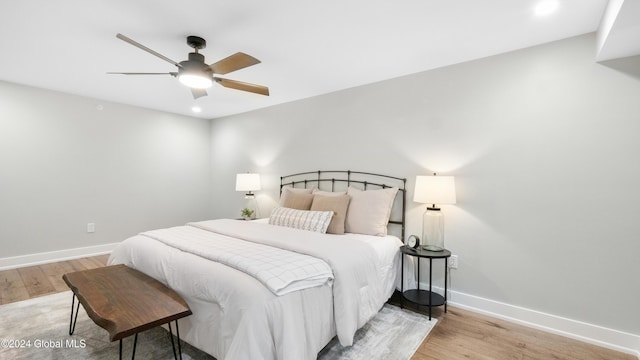 bedroom with light hardwood / wood-style floors and ceiling fan