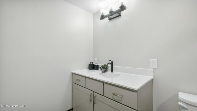 bathroom featuring vanity and toilet