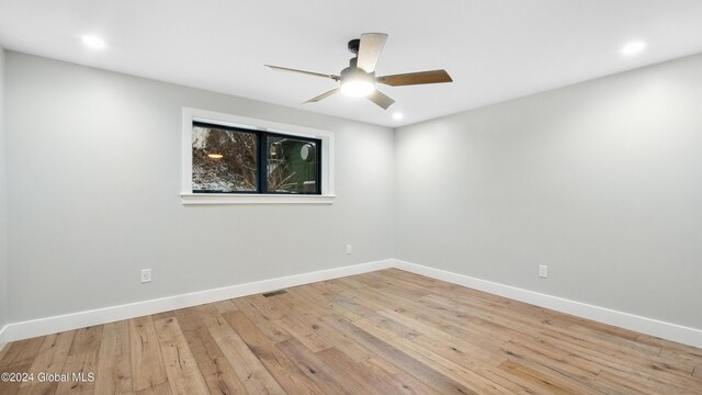 spare room with light hardwood / wood-style flooring and ceiling fan