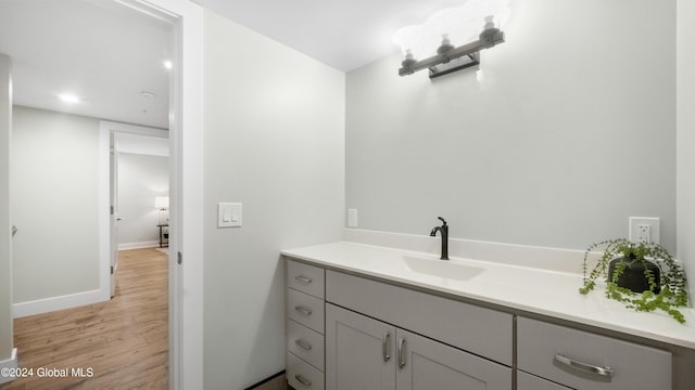 bathroom with hardwood / wood-style floors and vanity