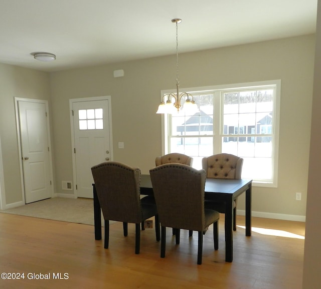 dining room featuring an inviting chandelier and light hardwood / wood-style floors