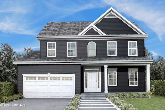 view of front of home with a garage and a front lawn