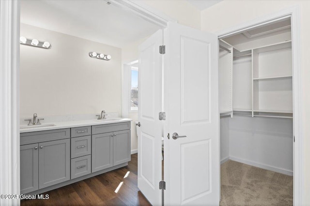 bathroom with wood-type flooring and double sink vanity