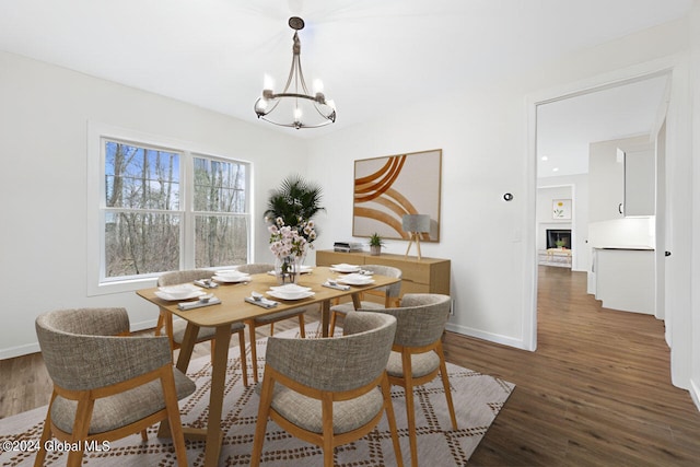 dining area with a chandelier and dark hardwood / wood-style flooring