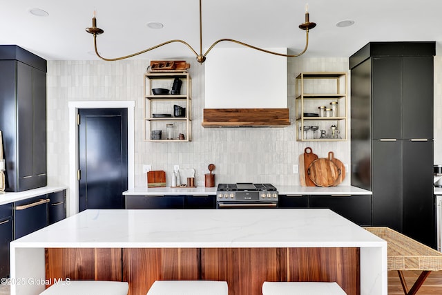 kitchen with premium range hood, a breakfast bar, high end range, and light stone countertops