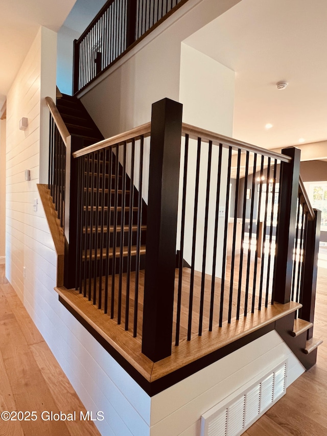 stairway featuring hardwood / wood-style floors