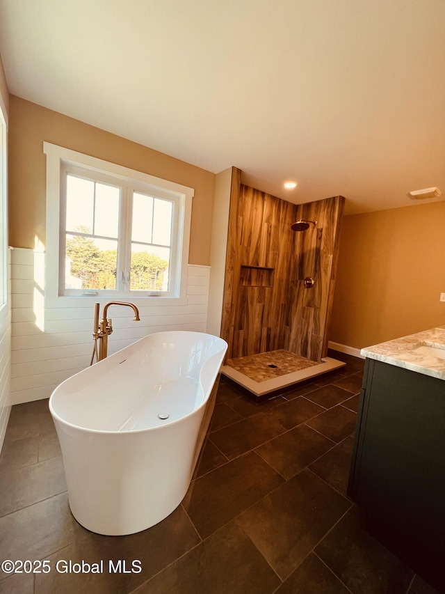 bathroom with vanity, shower with separate bathtub, tile patterned flooring, and tile walls