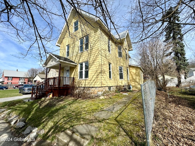 view of property exterior with a yard