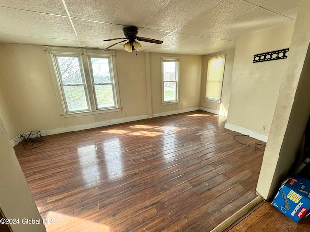 spare room with dark hardwood / wood-style flooring and plenty of natural light