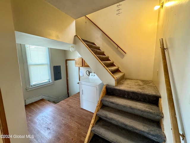 stairway with wood-type flooring and washer / dryer