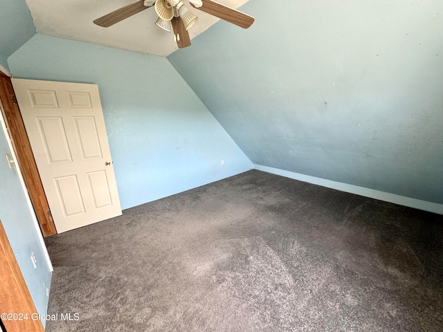 unfurnished bedroom featuring ceiling fan, carpet, and vaulted ceiling