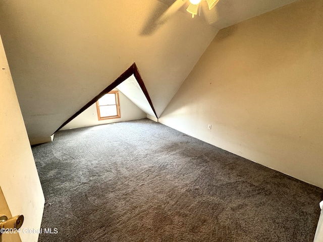 bonus room with carpet flooring, vaulted ceiling, and ceiling fan