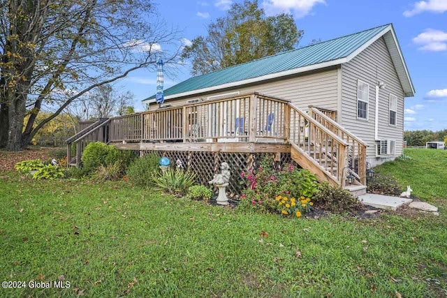 back of property featuring a yard and a deck