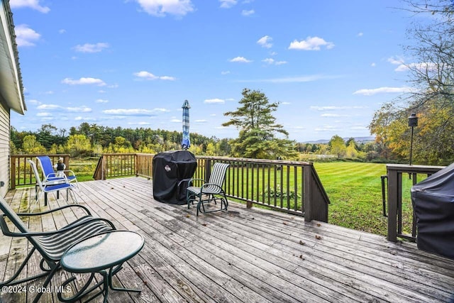 wooden deck featuring a lawn