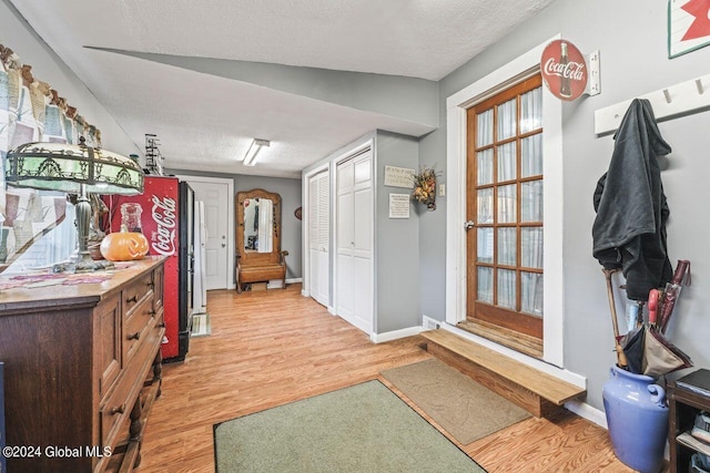 interior space with light hardwood / wood-style floors and a textured ceiling