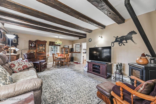 living room with a chandelier and beamed ceiling