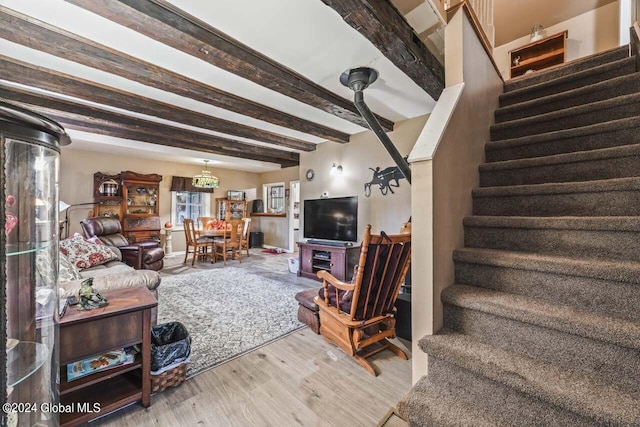 living room featuring light wood-type flooring and beamed ceiling