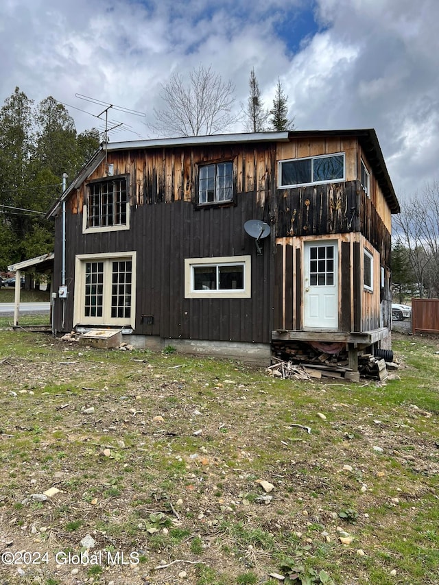 rear view of house featuring a lawn