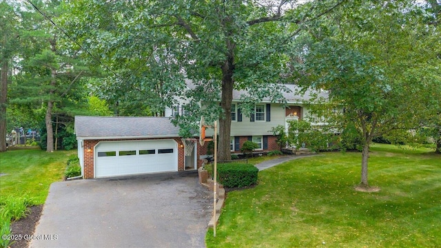 12 Lori Ln, Clifton Park, NY 12065 - view of front of house with driveway, a front lawn, brick siding, and a garage